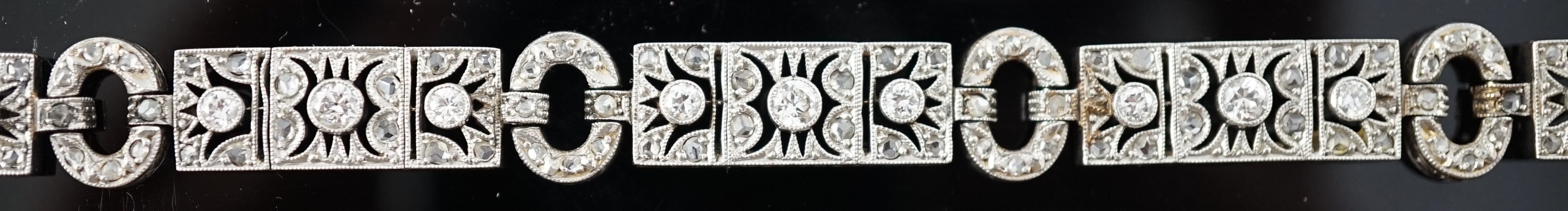 A 1920's pierced 18ct white gold and millegrain set round and rose cut diamond cluster bracelet